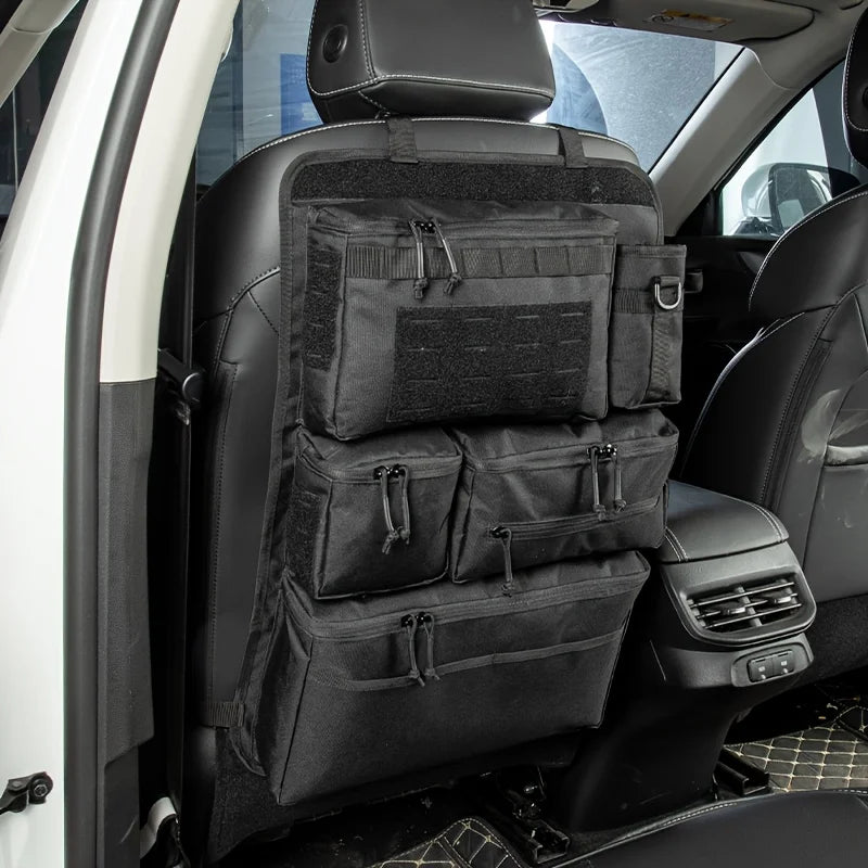 Black MOLLE seat back organiser hanging off front seat