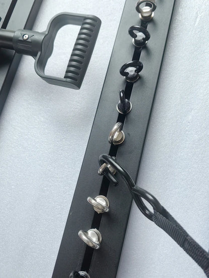 Eye bolts on a roof rack bar with tie-down strap hooked on