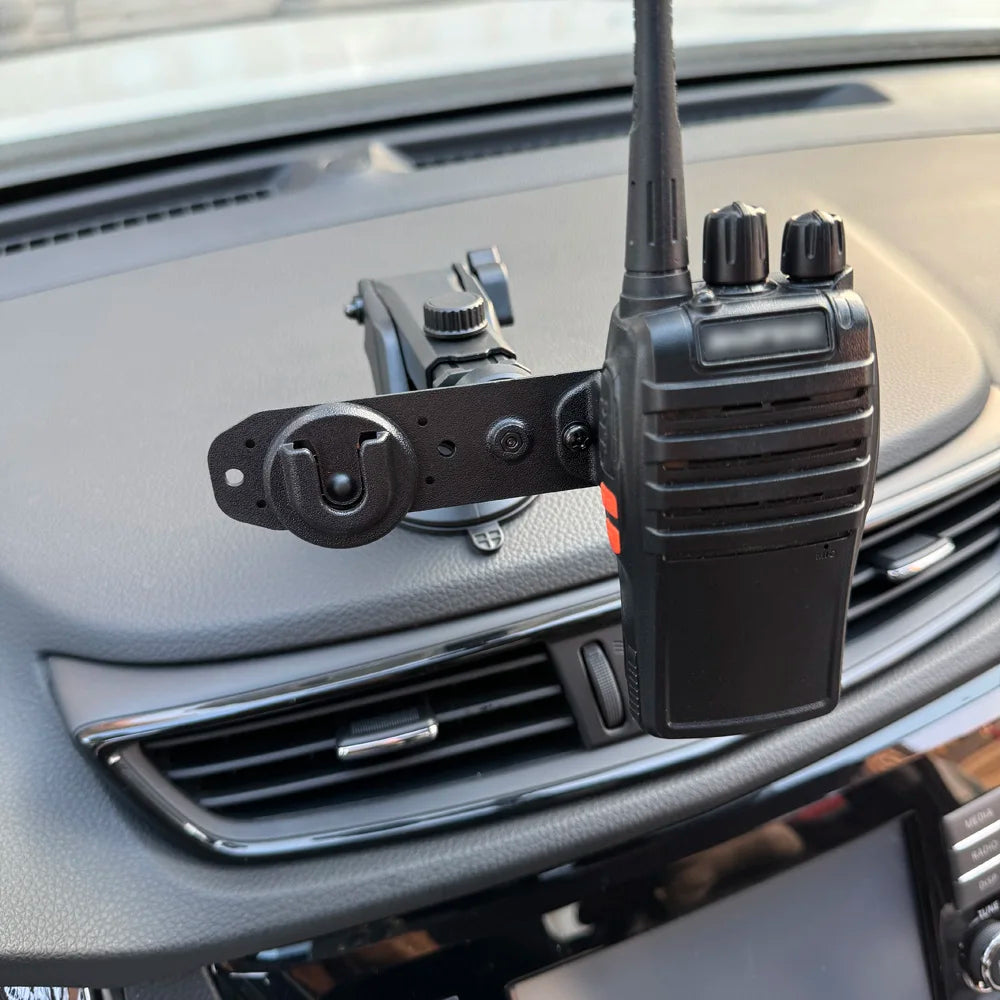 Handheld two-way radio clipped into the dash mount