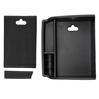 Armrest storage tray lifted out of the console bin