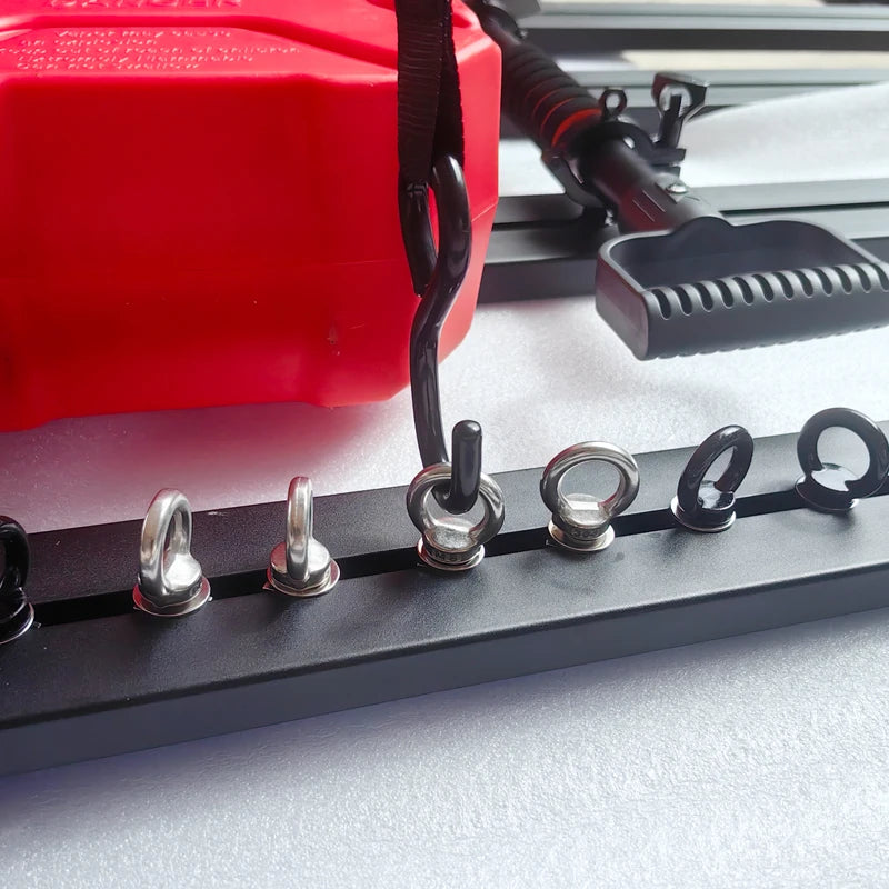Roof rack eye bolts holding a strap down on a jerry can