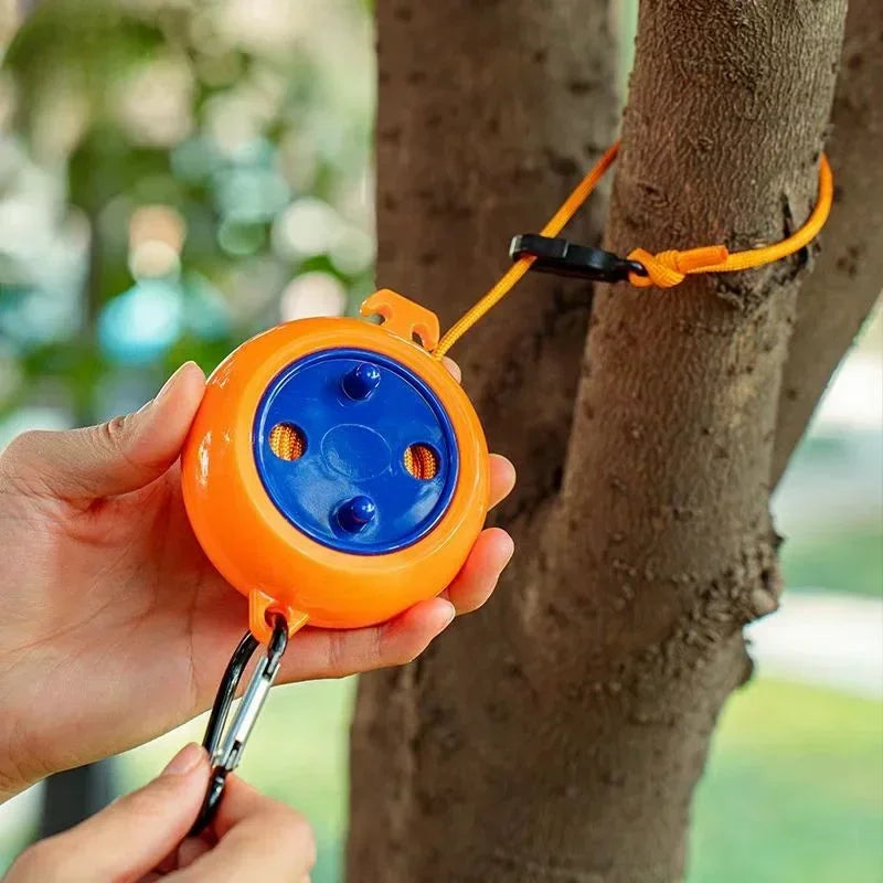 Retractable clothesline clipped around a tree at camp