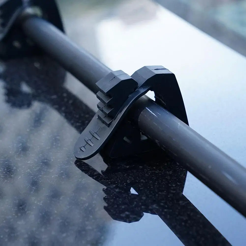 Rubber quick-release clamp holding a tube on a roof rack