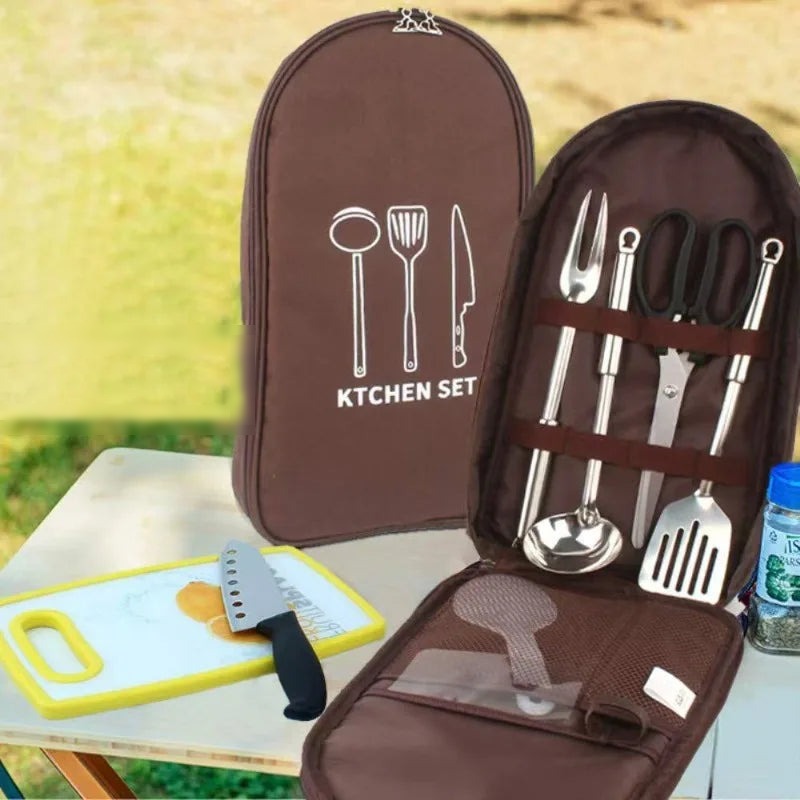 Camp utensil organiser bag open on a camp table showing utensil straps and pockets