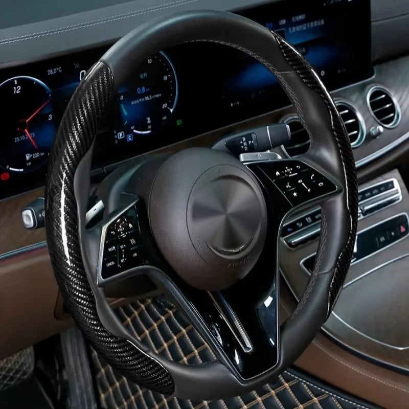 Black carbon-look steering wheel grip covers fitted